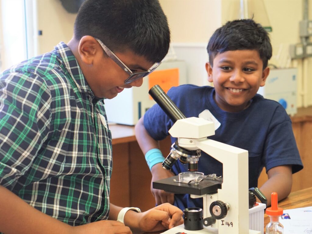 student using a microscope