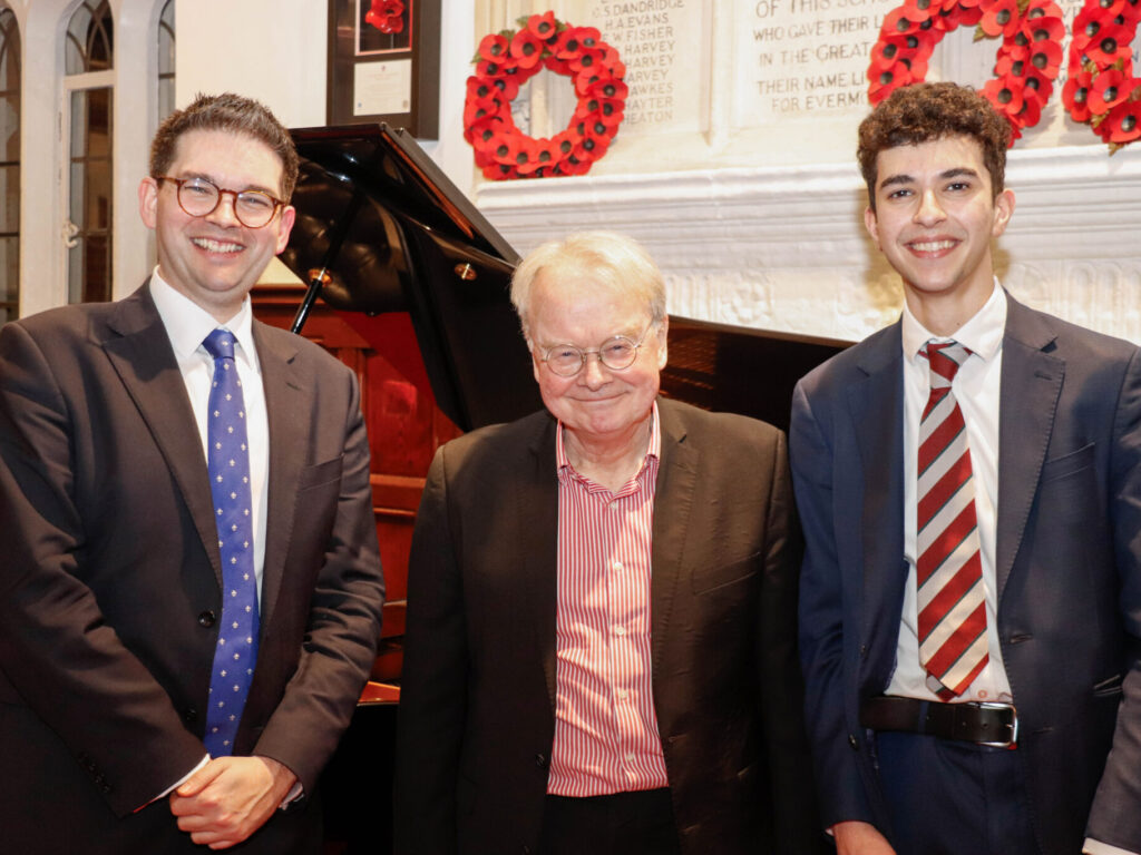 3 men by a piano